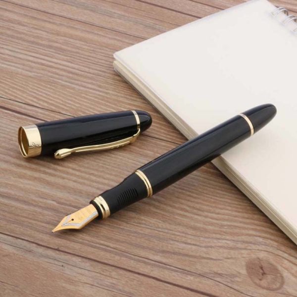 stylo plume épais avec une plume doré sur un support en bois